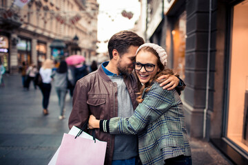 Young loving couple embracing each other on the street of a city