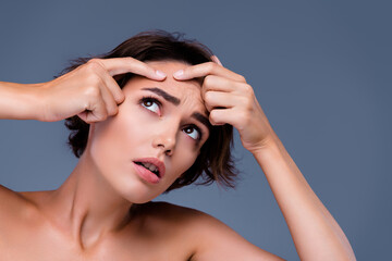 Fototapeta premium Photo of sad lady on daily morning hygiene routine look mirror touch pimple dry skin concept over grey background