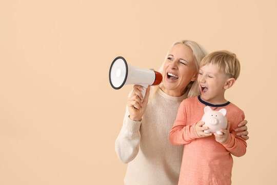 Little boy with his grandmother and piggy bank shouting into megaphone on beige background - Powered by Adobe