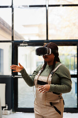 Supervisor checking clients online orders using virtual reality headset before start preparing packages in storage room. African american manager wearing industrial overall during goods inventory