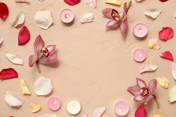 Frame made of burning candles and beautiful flowers on grunge beige background. Divaly celebration