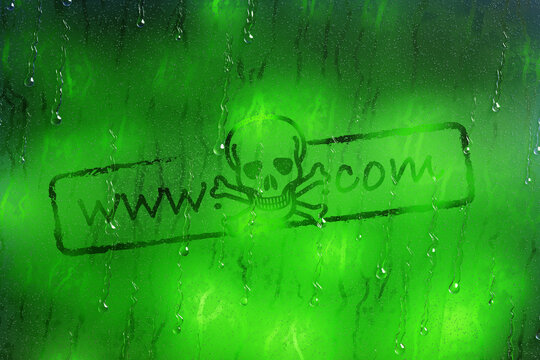 Skull logo acts as a dot com domain name on a glass with raindrops flowing down on green bokeh background. Illustration of the concept of danger of uncensored Internet content and dark webs