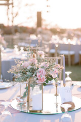 elegantly decorated table at a wedding reception with beautiful sunset