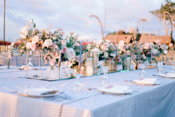 elegantly decorated table at a wedding reception with beautiful sunset