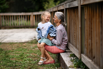 Grandmother and granddaughter playing in the park