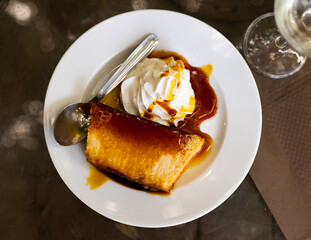 Indulge in creamy, delectable pudding served elegantly on pristine porcelain plate.