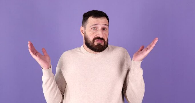 Young handsome bearded man making I don't know gesture on purple background. 