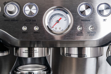 Modern espresso coffee machine. Control buttons and barometer. Close-up.
