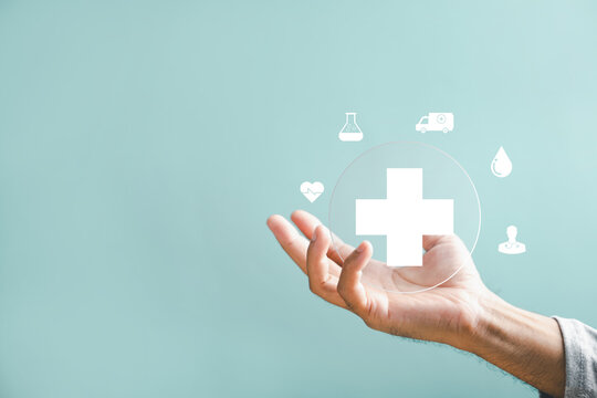 A hand holds a plus icon for medical care, indicating advantages. Health insurance health concept featuring access to welfare health and room for content.