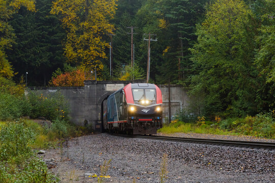 Skykomish, WA, USA - October 22, 2023; Amtrak Empire Builder passenger train emerges from Cascade Tunnel