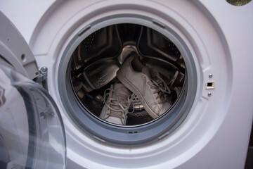 Dirty old sneakers waiting to be washed in the washing machine
