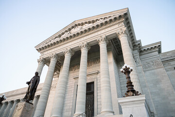 concrete architectural aspects with columns and etchings and statues