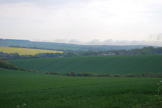 Overcast Sky Stormy Grey Clouds English British Rolling Lush Green Hill Countryside Fields & Farmland Travel Photography Landscape Vista Bright Shades & Tones of Green & Yellow