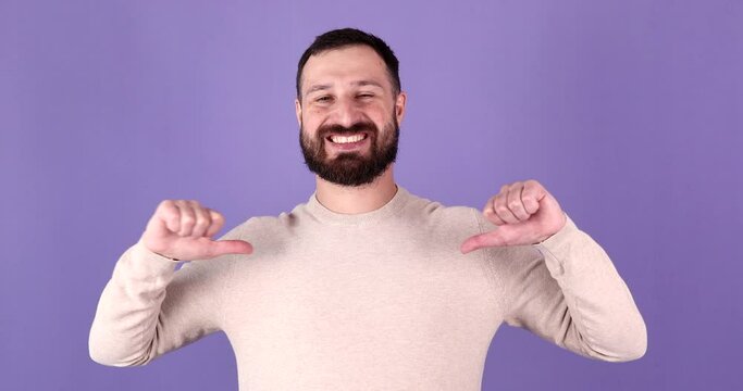 Excited bearded man pointing at self isolated on purple background. Pick me concept.