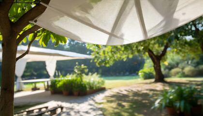 white awning in garden with blurry shadow of a tree in sunny summer day