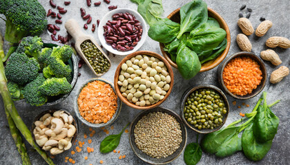 vegan protein source legumes beans lentils nuts broccoli spinach and seeds top view on stone table healthy vegetarian food - obrazy, fototapety, plakaty