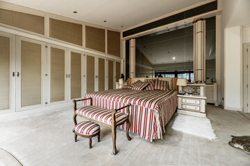 Large vintage-style double bedroom with matching shoehorn furniture and built-in wardrobes covering...