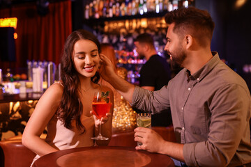 Lovely couple with fresh cocktails in bar
