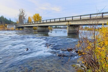The swift moving Priest River in autumn.