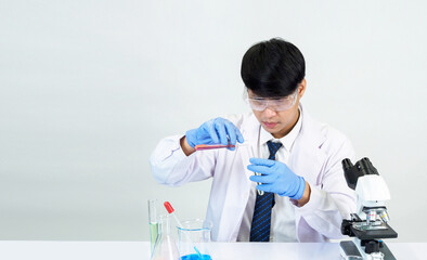 Portrait asian man student scientist Wearing a doctor gown in the lab looking hand at chemist....
