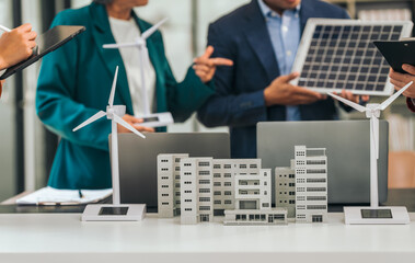 Group of asian business people meeting boardroom clean energy solutions. discussing solar panels, wind turbines, suggesting ideas for sustainable city. mature teaching, grey hair people, young adult