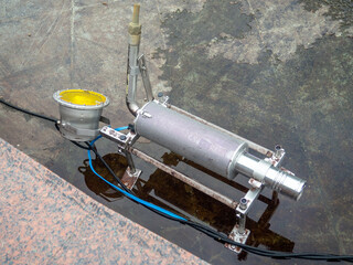 Empty fountain in a city park. Dehumidification. Cleaning the fountain with a hose. The device of the fountain. Pipes for water supply. Water hoses. Modern technologies.