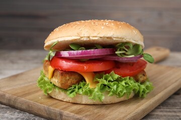Delicious burger with tofu and fresh vegetables on table, closeup