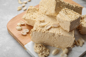 Pieces of tasty halva on light gray table, closeup