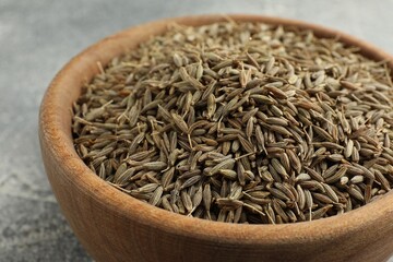 Bowl of caraway seeds on table, closeup