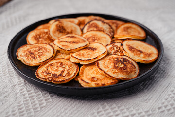 Mini pancakes in a black plate