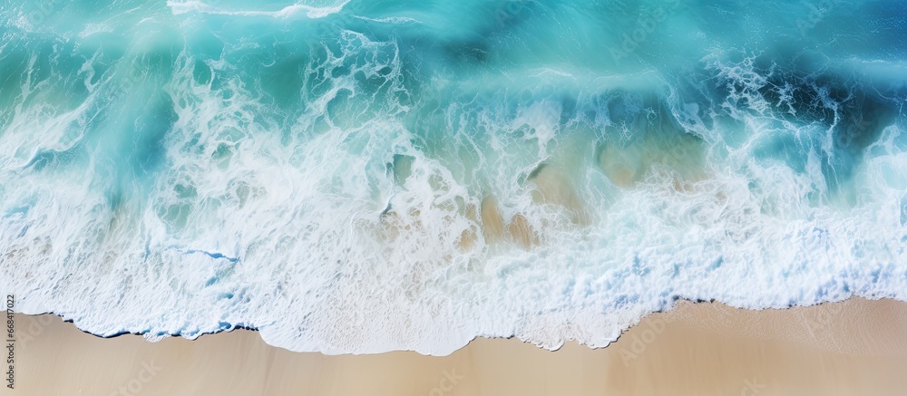 Poster top down view of waters abstract texture with waves and sand serving as a turquoise background