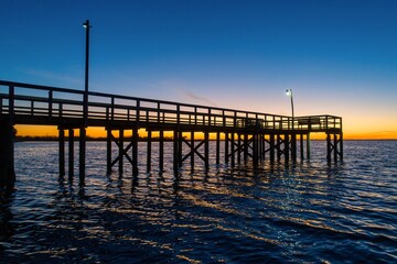 Fototapeta na wymiar Pier at sunset on Mobile bay