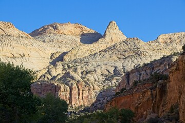 A drive through the northern edge of Capitol Reef National Park brings you along a winding surrounded by steep, beautiful red rock walls