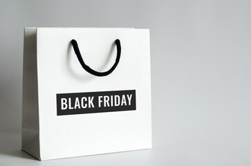 White shopping bag with Black Friday word on white background for Black Friday shopping sale concept.