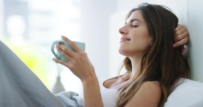 Relax, smile and woman with coffee cup in bedroom, peace and dance for freedom in home. Happy person with tea mug in bed, comfort and awake with latte, breakfast drink and espresso in the morning.