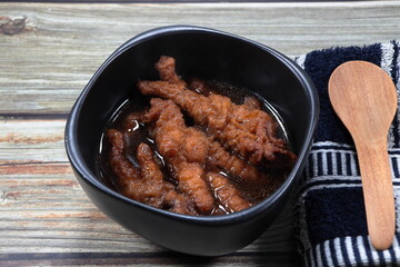 Traditional steamed chicken feet in gravy sauce serving in the bowl. Famous dim sum menu in Asian restaurant. 