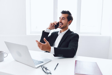 Looking man businessman computer smiling entrepreneur business phone office young executive technology talk laptop