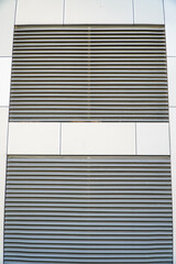 Detail of the facade of a modern office building with blinds,Office building louvers, metallic shutters