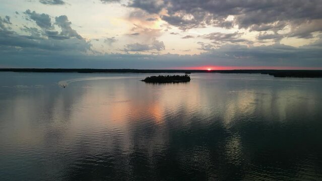 Aerial view of Chris Craft boat on flat water at sunset, Les Cheneaux Islands, Michigan