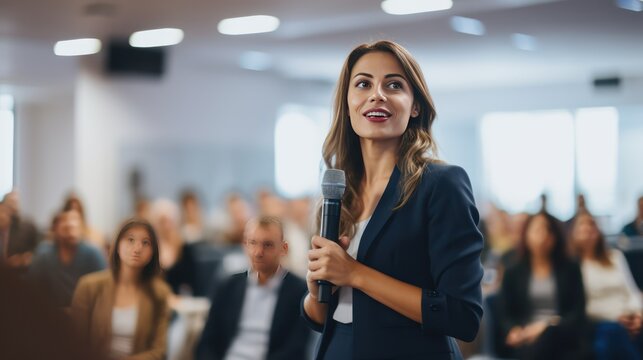 A Business and Entrepreneur Expo with female speakers giving presentations on company business meetings. Unknown people in the audience at the conference room.
