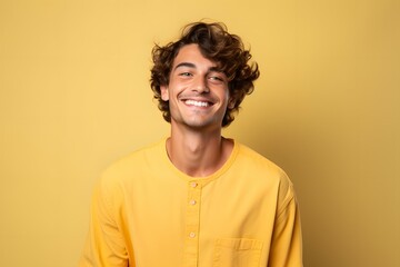 Fototapeta premium portrait of a happy young man on a yellow background
