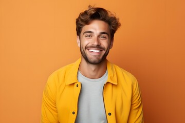 Fototapeta premium portrait of a happy man on a yellow background