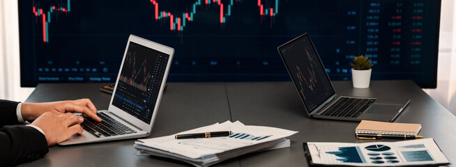 Stock trading investor monitoring dynamic financial data graph for profitable trade. Businessman or broker with analytic thinking analyzing data for stock market exchange trading company. Trailblazing