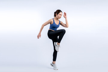 Side view young athletic asian woman on running posture in studio shot on isolated background....