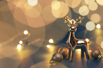 Christmas golden deer with decorations on dark background