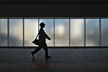 Niigata, Japan - October 25, 2023: Silhouette of people walking in front of frosted glass window 
 - Powered by Adobe