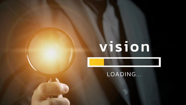 The vision is loading with a business man is holding a magnifying glass in his hand.
