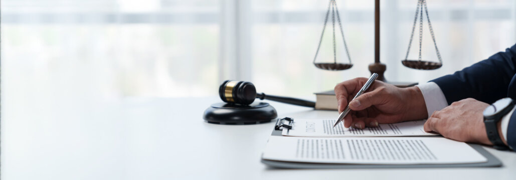 Young Asian lawyers or lawyers sitting analyzing business deals on real estate financial documents at the office panorama, banner, copy space
