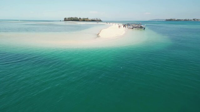 Aerial of the pristine Indonesian island of Lombok, an hidden gem that captivates travelers with its otherworldly beauty.  Gili Kere epitomizes the beauty of an untouched island.