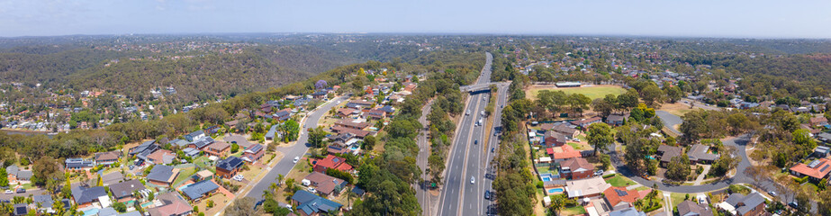 Fototapeta na wymiar Panoramic aerial drone view of homes and streets above Bangor in the Sutherland Shire, south Sydney, NSW Australia showing Bangor Bypass in the background 